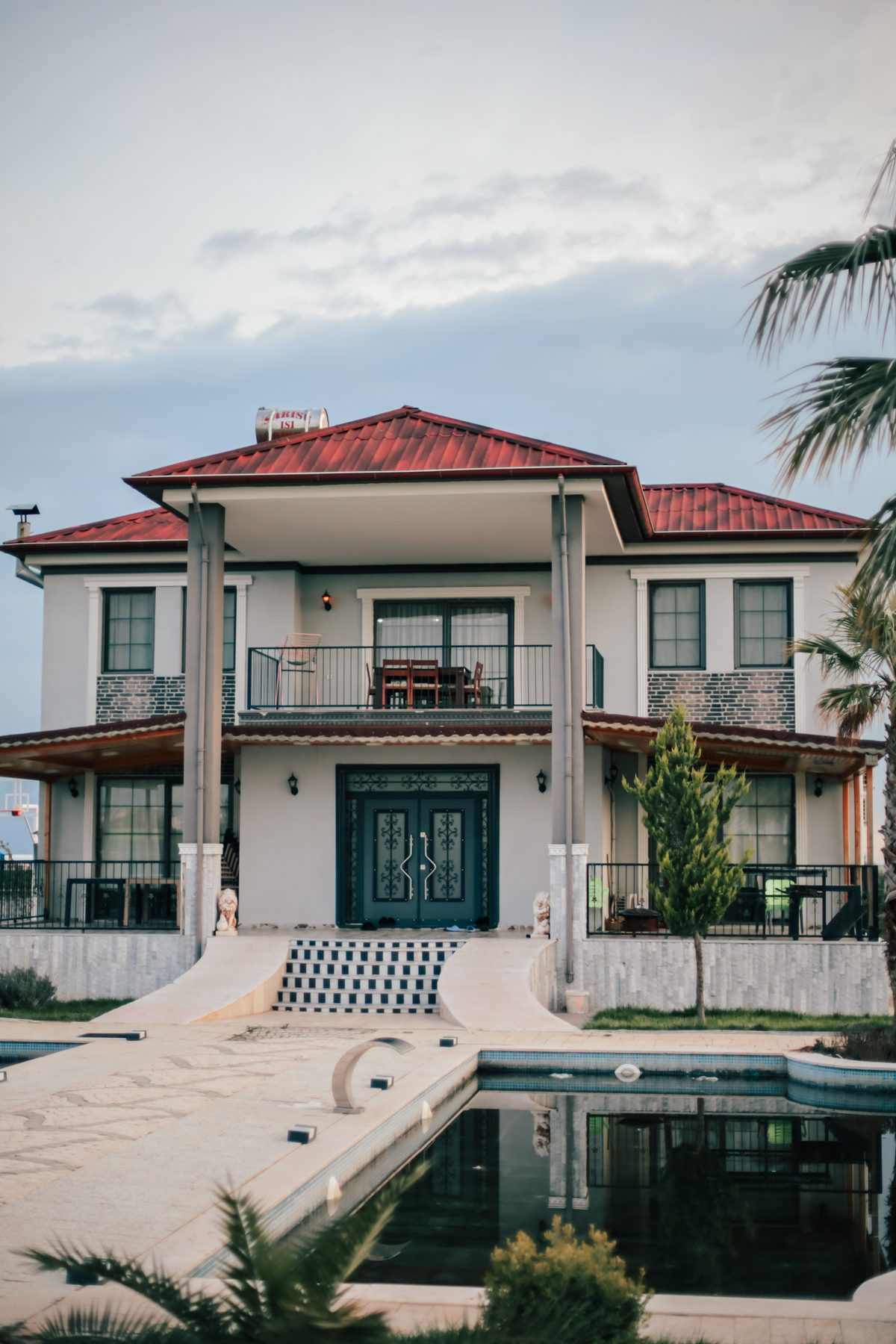 Long swimming pool beside a modern villa